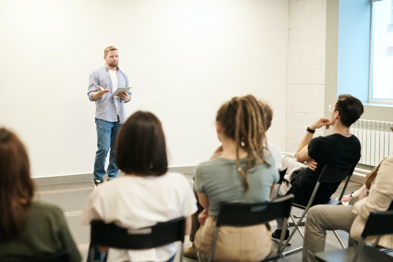A man speaking infront of other people