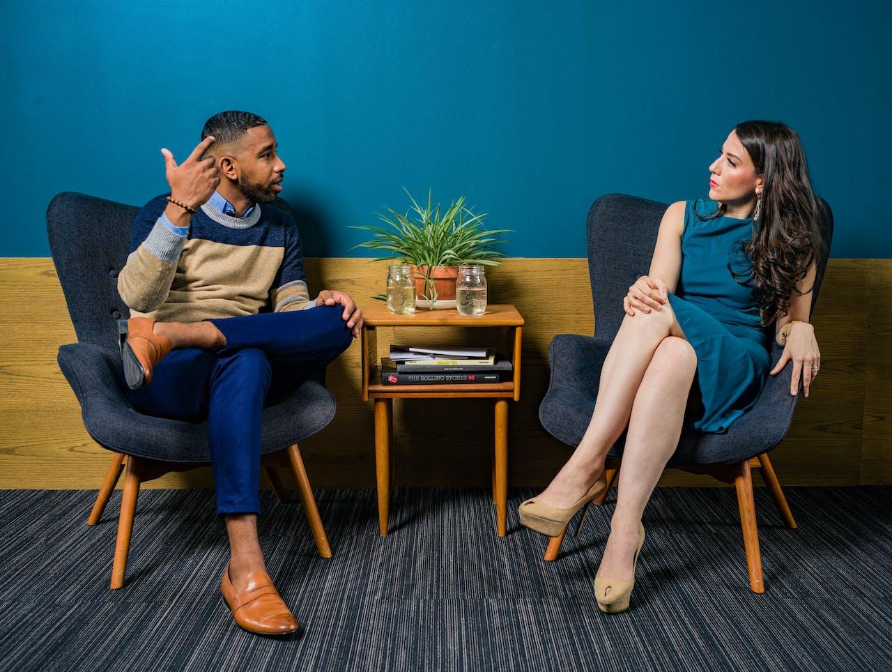 a man and woman talking to each other